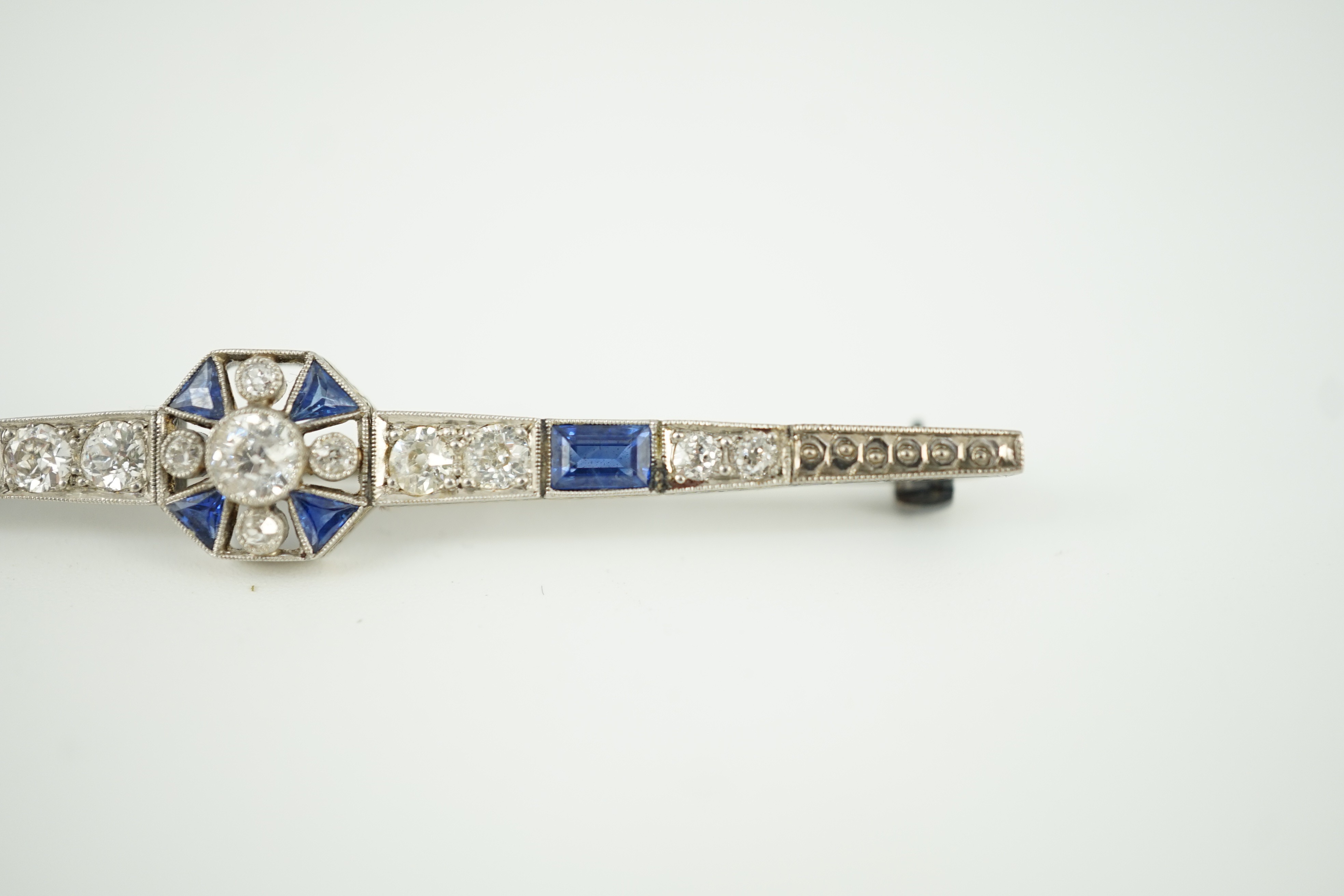 A 1920's/1930's white gold, sapphire and diamond cluster set bar brooch